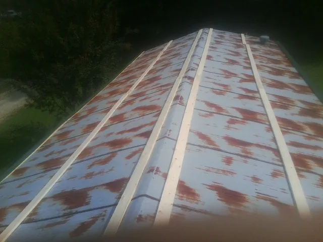 Rusted metal roof panels with new wood purlins before replacement in Beersheba Springs