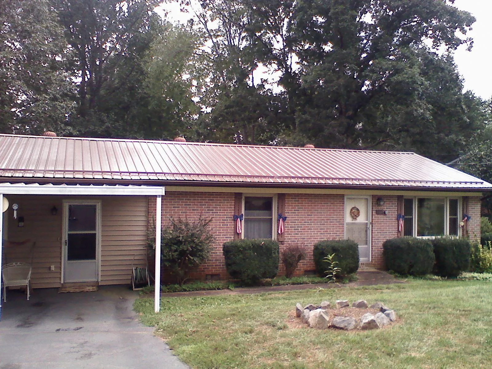 Bronze metal roof and carport on a brick ranch home — Roof Repair work by our crew in Beersheba Springs